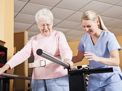 Physical therapist with senior woman, gait training