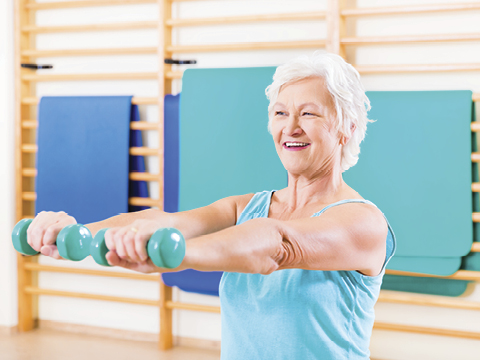 Senior woman doing fitness sport in gym